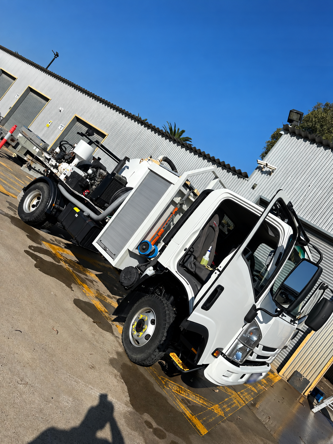 Plain white specialist service truck with plate obscured